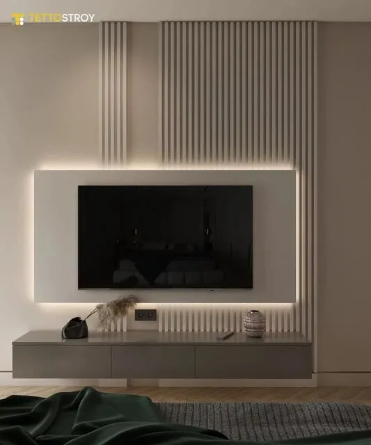 TV zid sa letvicama i LED svetlom oko ravne površine Bež TV zid sa letvicama i LED svetlom koje uokviruje ravnu površinu iza televizora